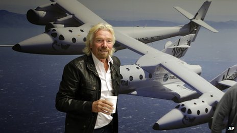 Branson on the background of a photo of SpcaeShipTwo - a spaceship for tourism