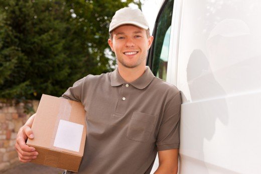 <a href="http://www.shutterstock.com/pic-89594563/stock-photo-postal-service-delivery-of-a-package-through-a-delivery-service-the-postman-is-leaning-on-his-van.html">Shutterstock / Kzenon</a>
